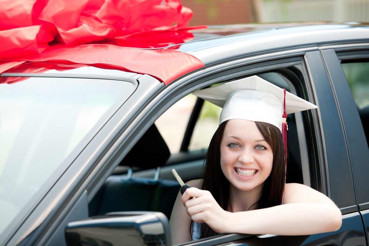 An international student reaching for the car key while sitting in a leased car.